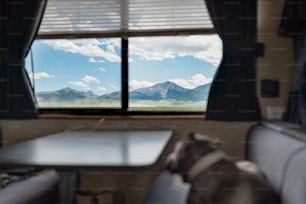 a view of mountains out a window of a recreational vehicle