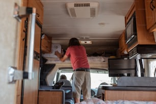 a woman standing in the back of a truck