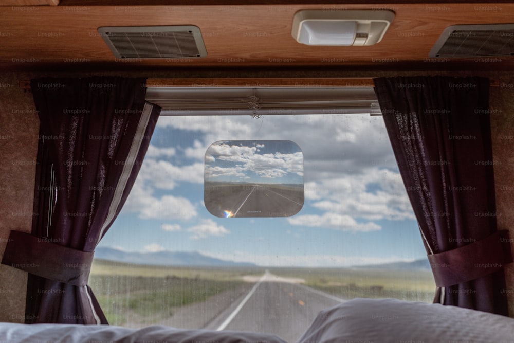 a view of a road through a window of a vehicle