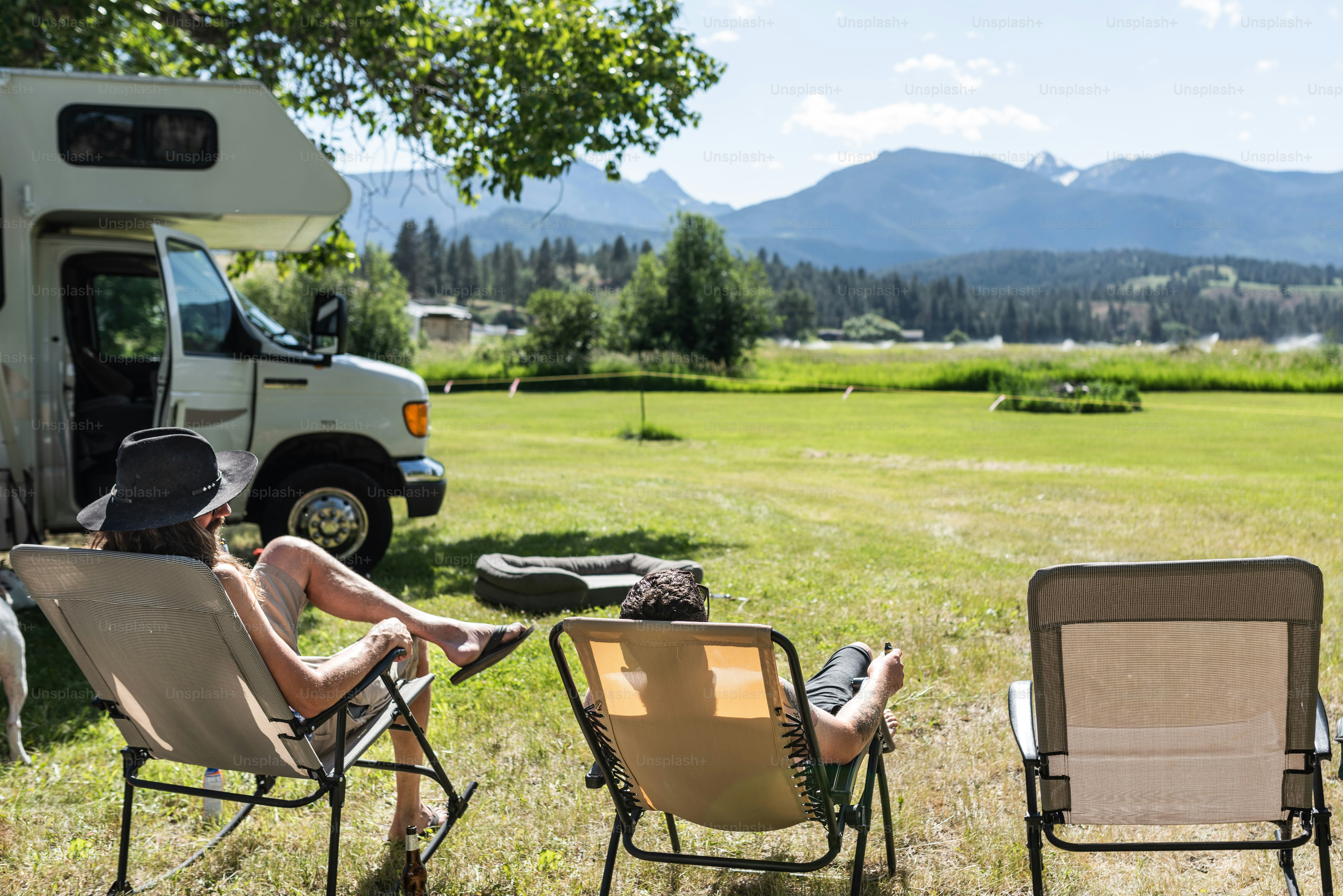 a couple of chairs that are in the grass