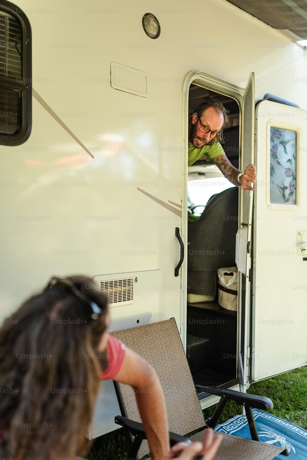 a man opening the door of a recreational vehicle
