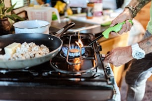 a person is cooking food on a stove