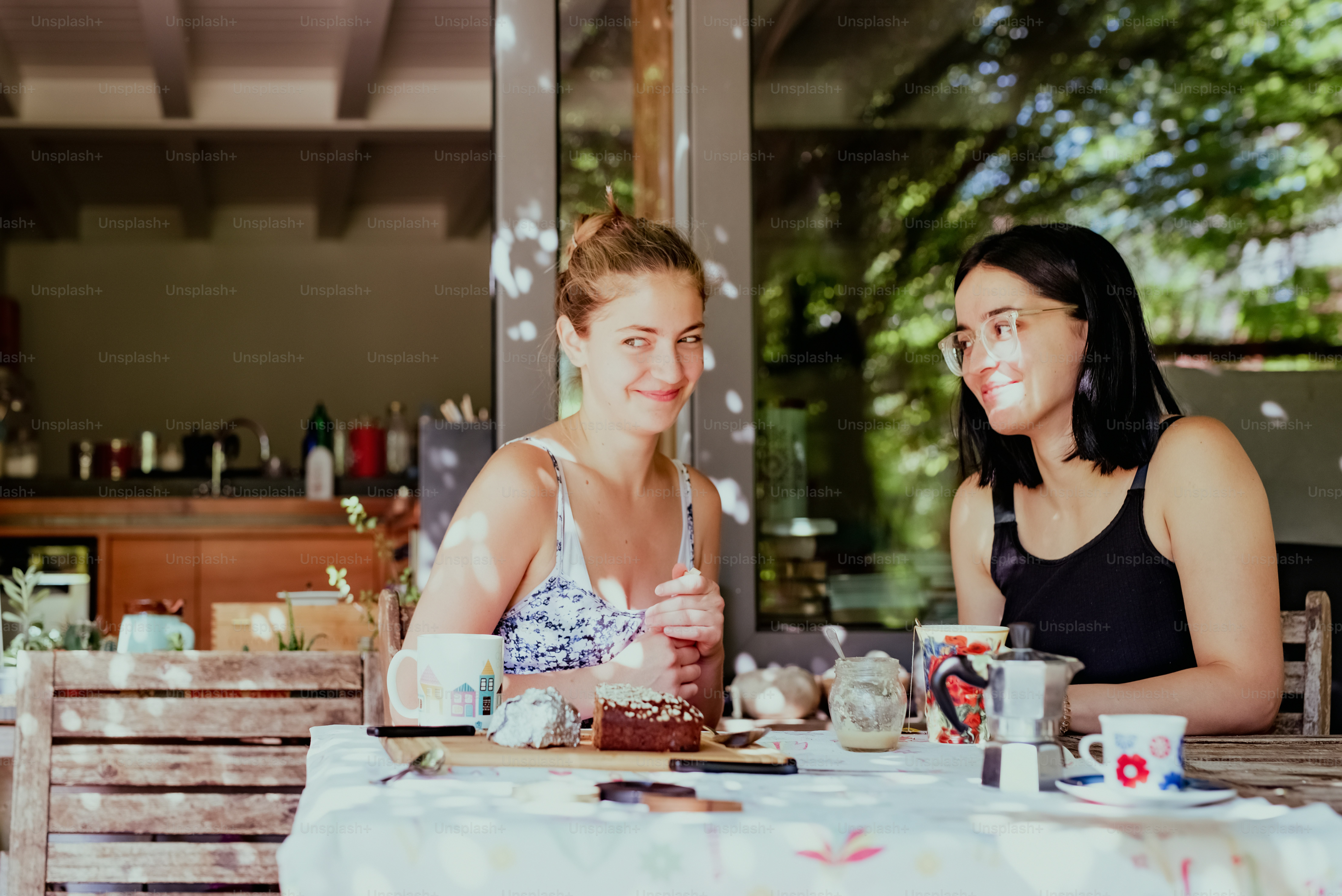a couple of women sitting at a table