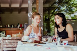 a couple of women sitting at a table