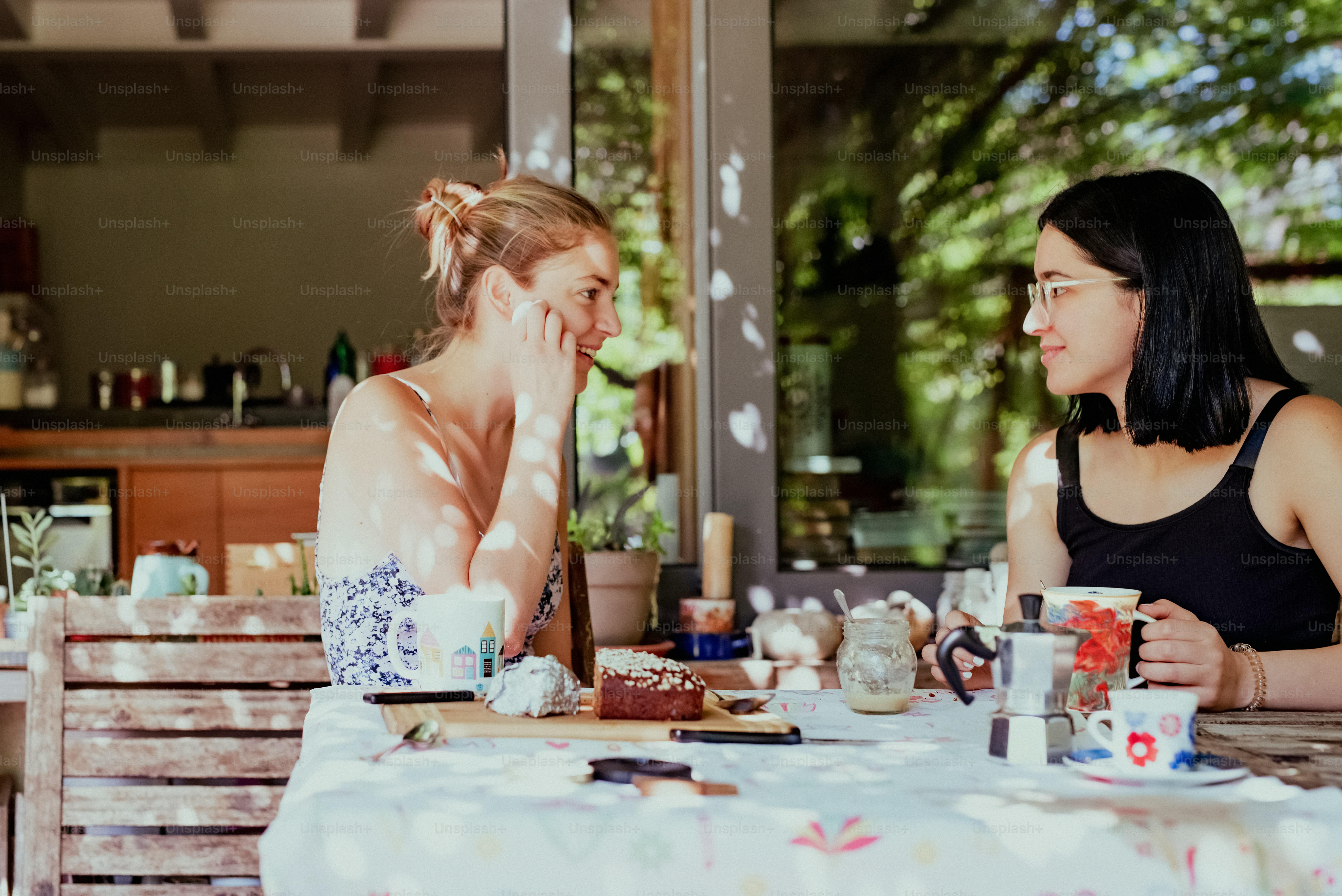 a couple of women sitting at a table