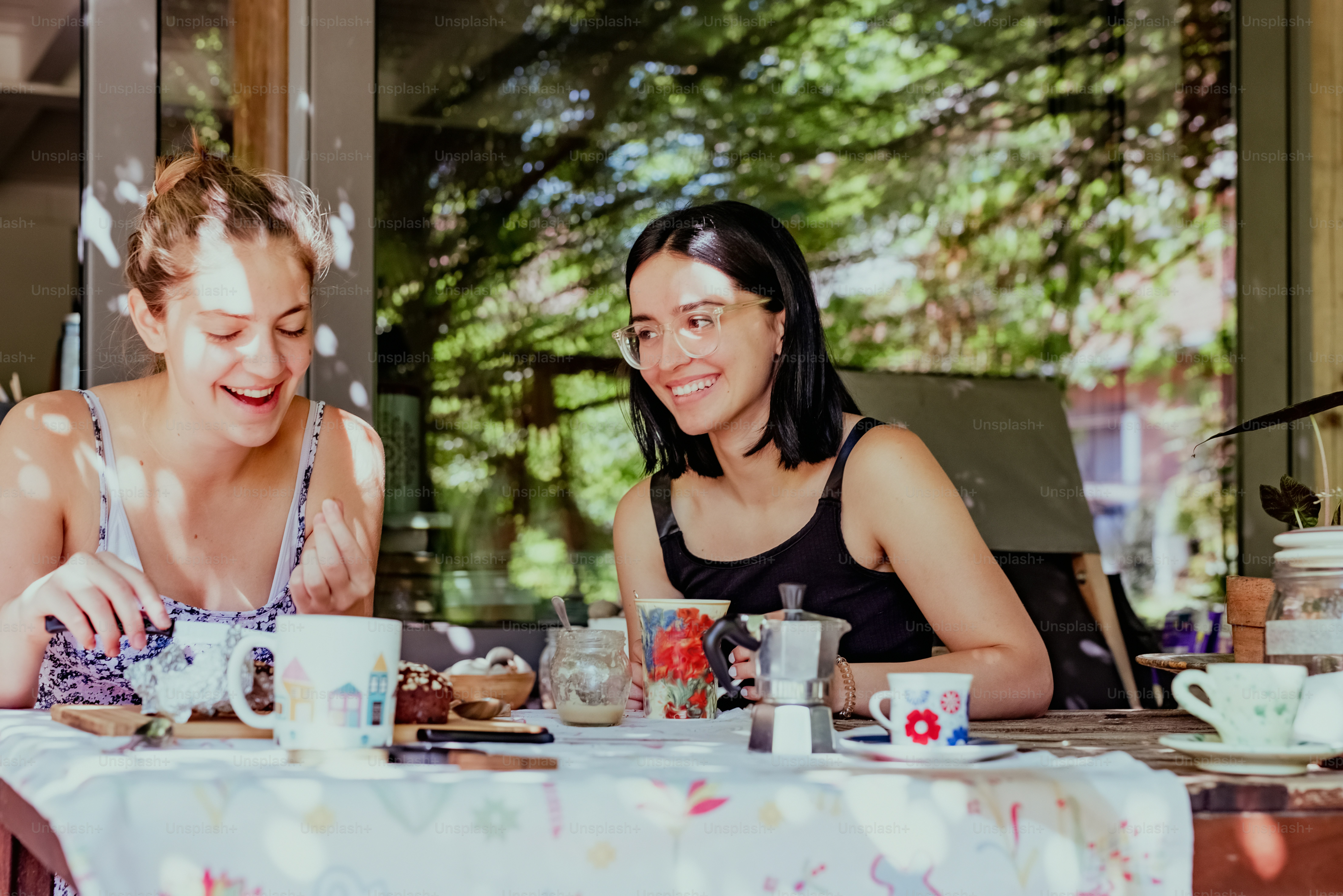 a couple of women sitting at a table