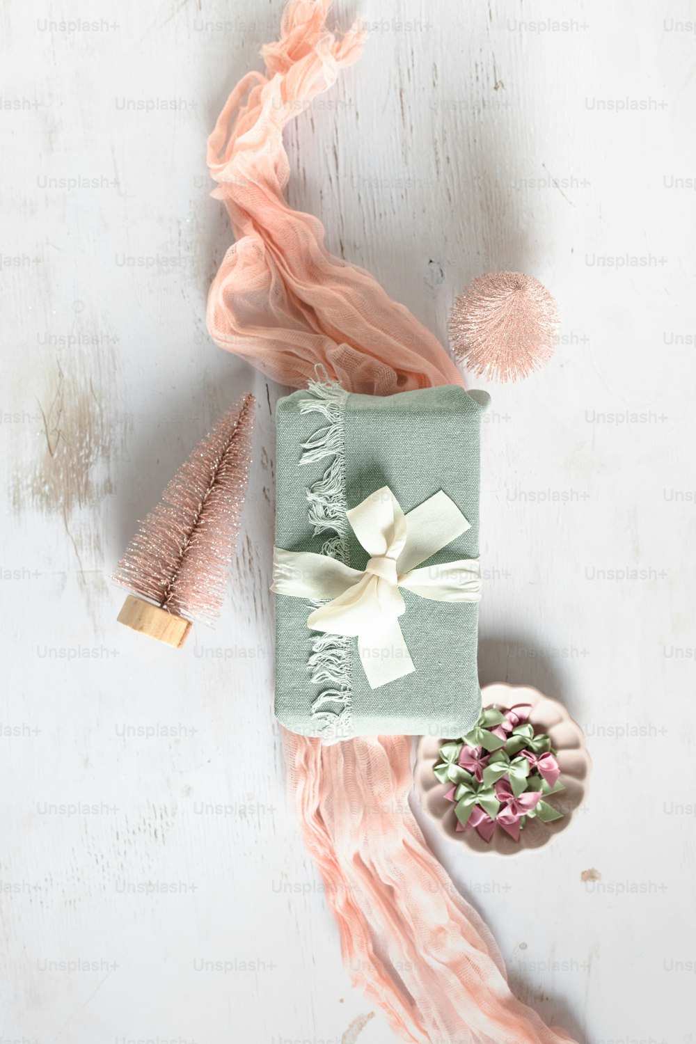 a gift box with a ribbon and a pom pom
