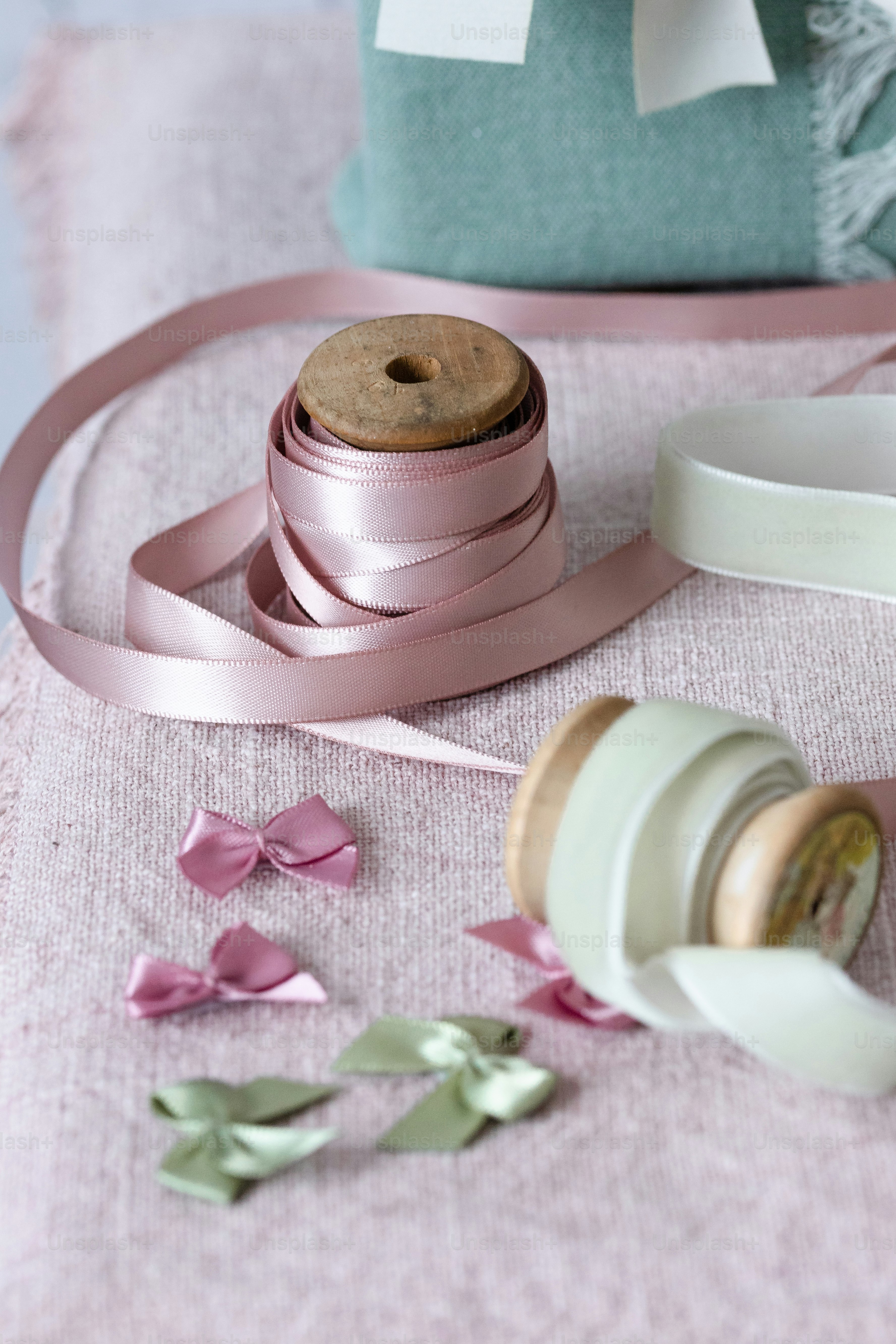 a roll of pink ribbon next to a bottle of wine