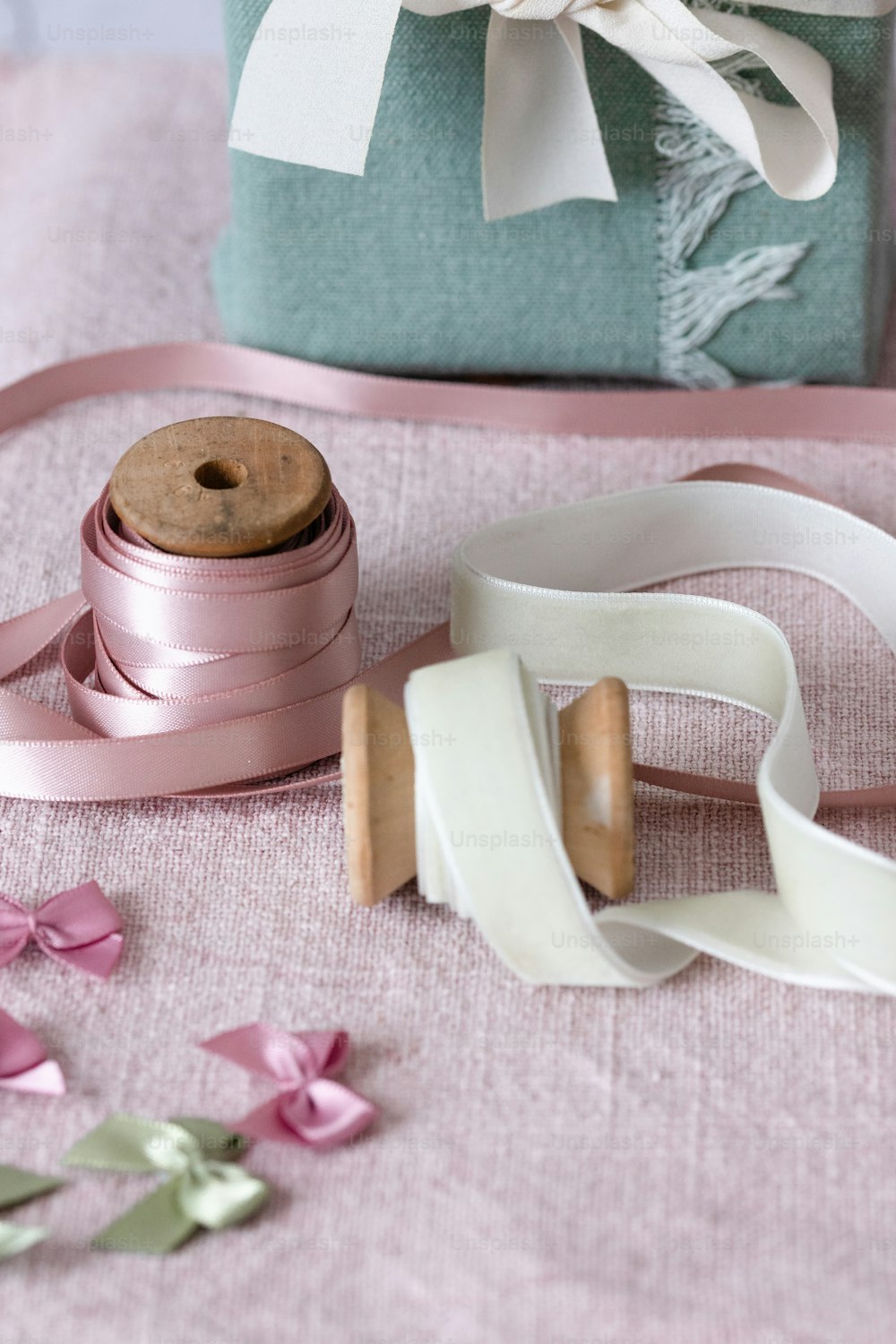 a roll of ribbon and a spool of thread on a table