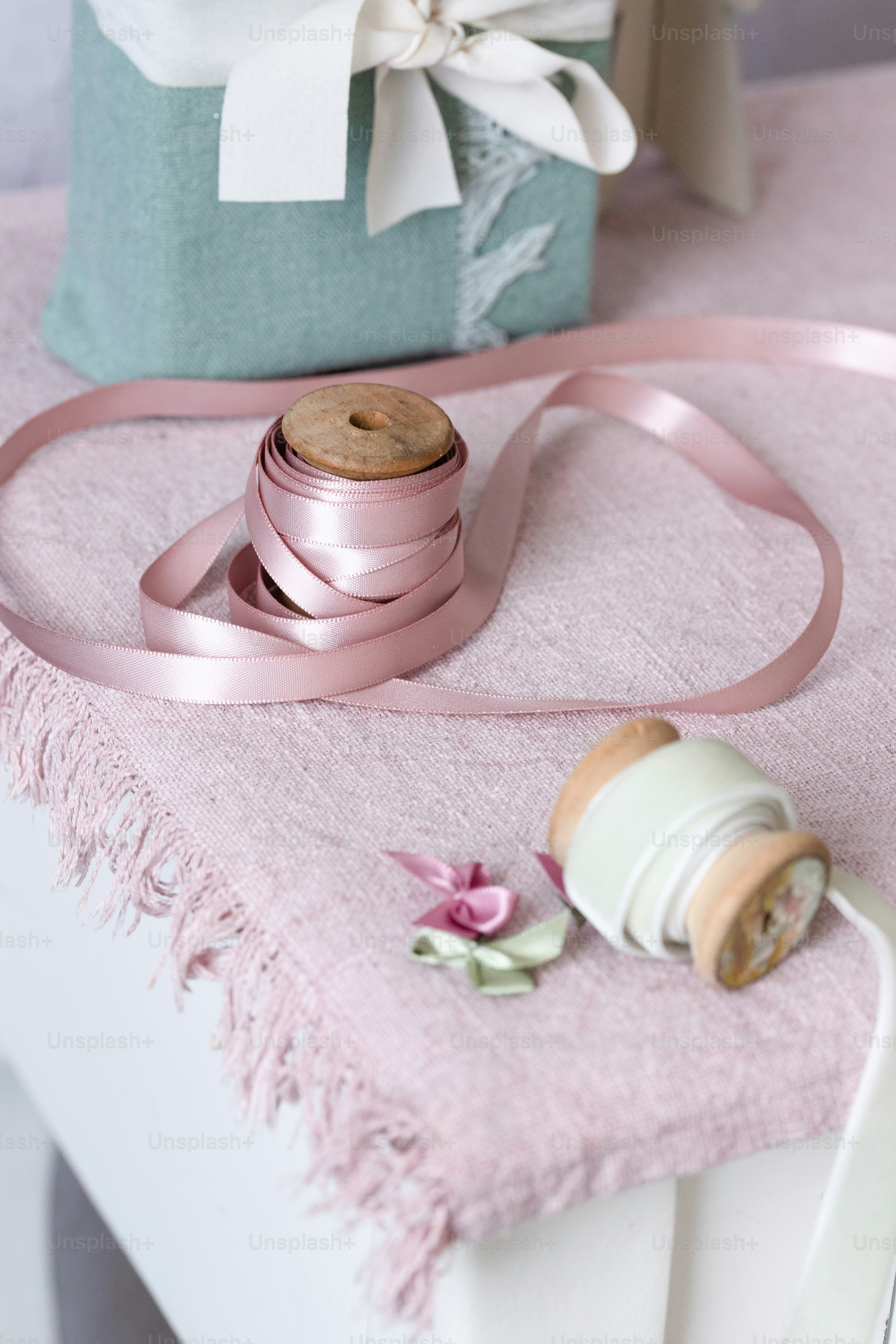 a pink table cloth with a pink ribbon and a bottle of wine