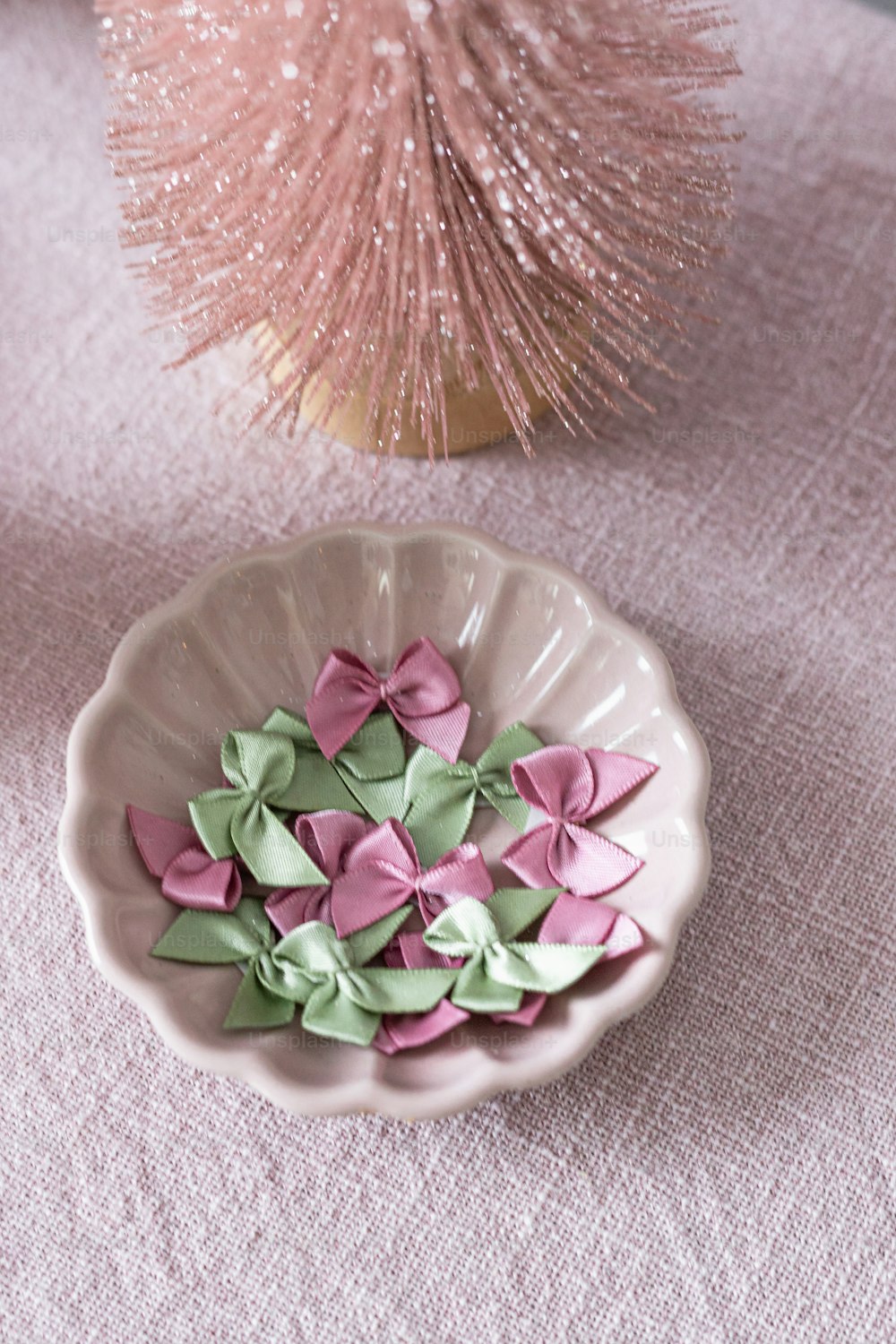 pink and green paper flowers in a bowl