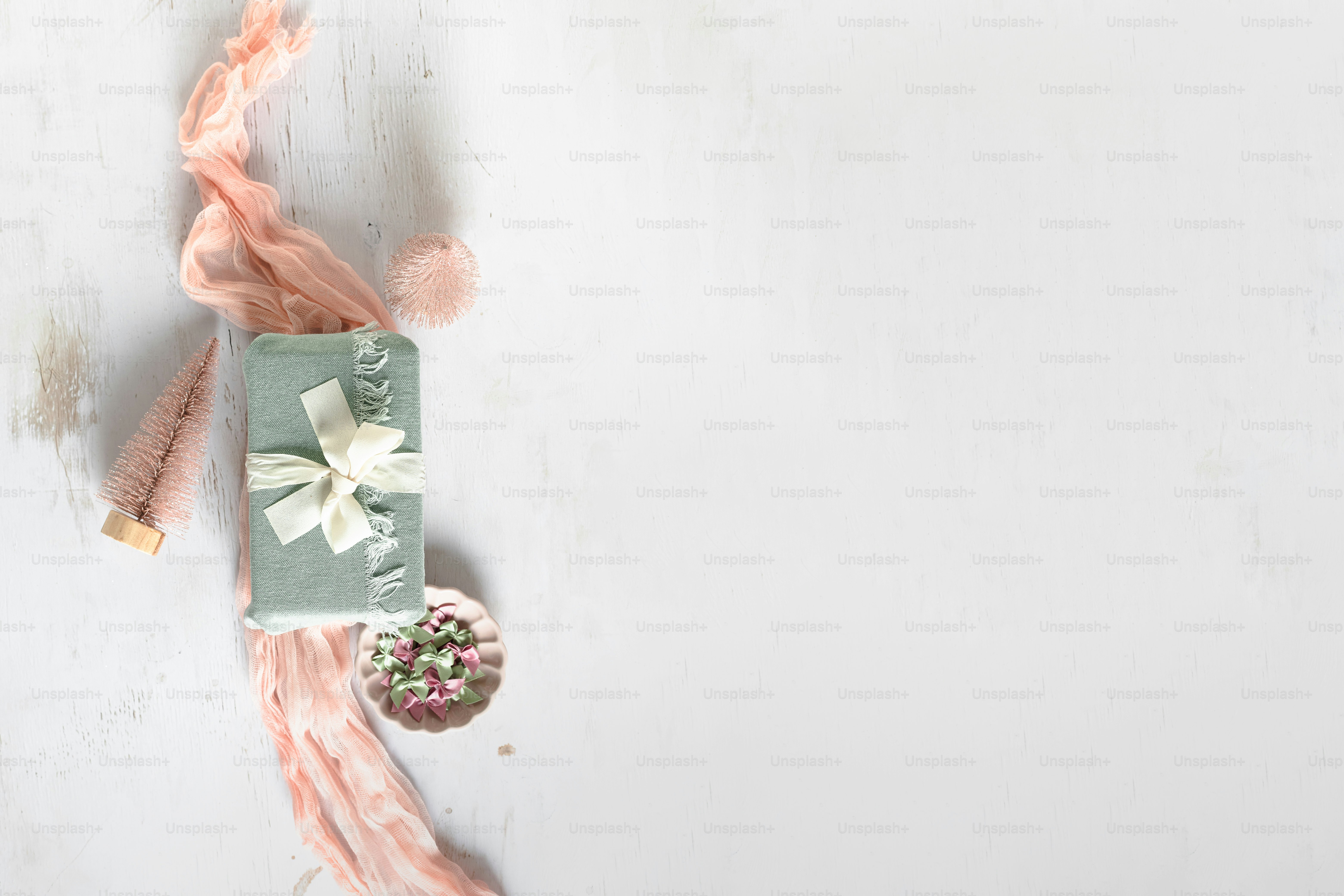 a white table with a gift and a flower arrangement