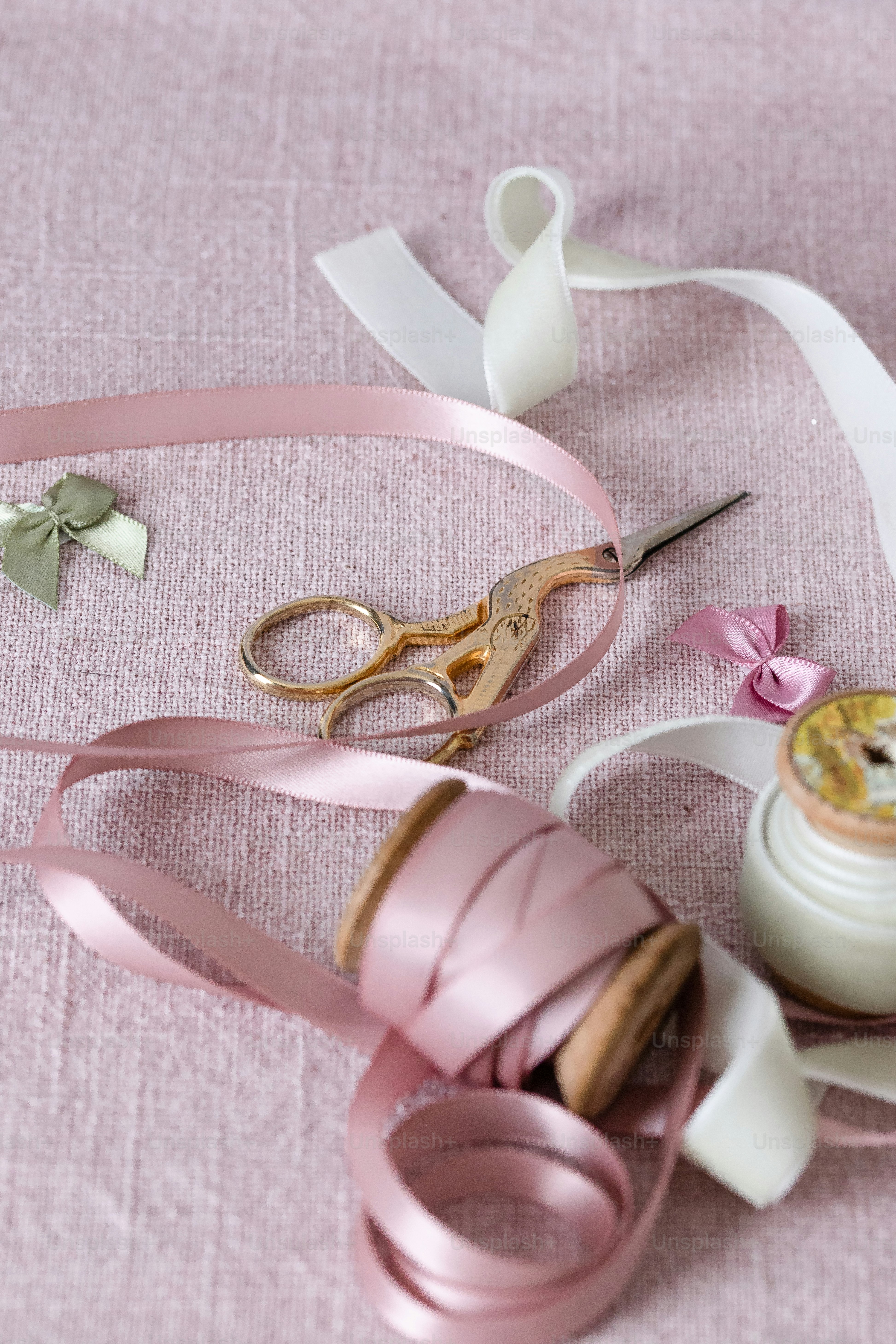 a pair of scissors and some ribbon on a table