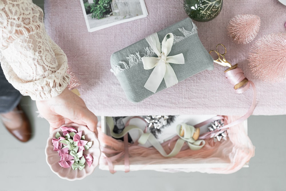 a table with a pink table cloth and a gift