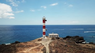 aerial view of beautiful landscape with lighthouse old and new on the cliff of Tenerife in front to the Atlantic ocean. Lonely cyclist arriving