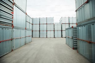 Abundance of sealed metal cargo containers stacking outdoors, shipping storage