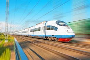 High speed train rides at high speed at the railway station in the city