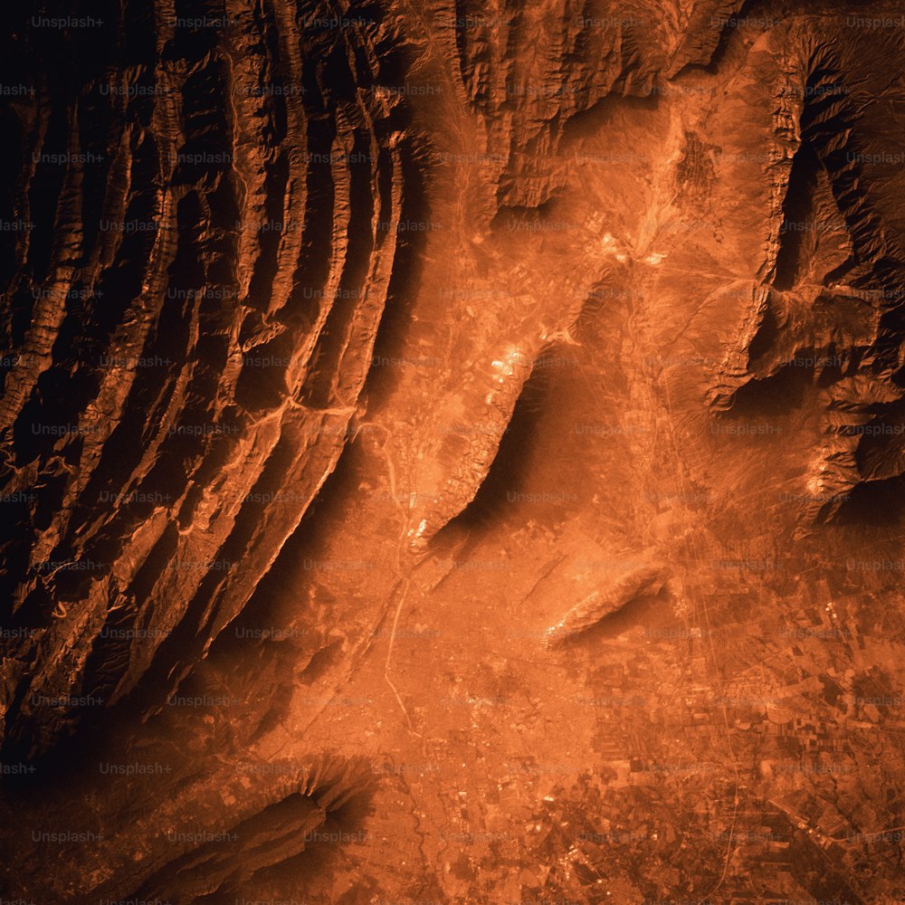 a red and black photo of a rock formation