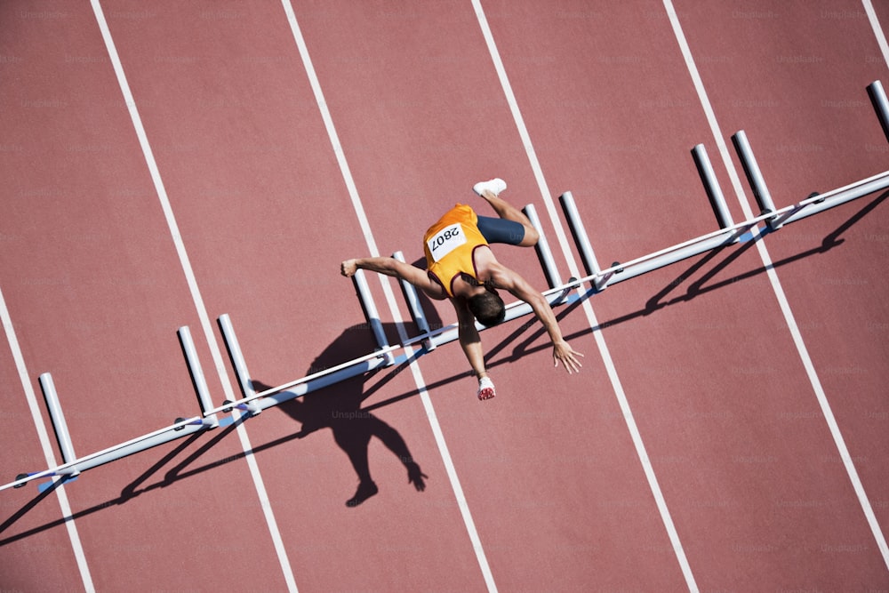 a man on a track with his hands in the air