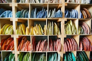 Background of shelves with colorful patterns for mosaic artwork in workshop of artisan