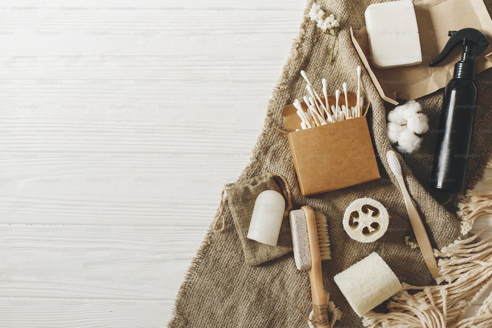 zero waste concept, sustainable lifestyle flat lay. natural eco bamboo toothbrush, coconut soap, handmade detergent, crystal deodorant, luffa, bamboo ear sticks. go green