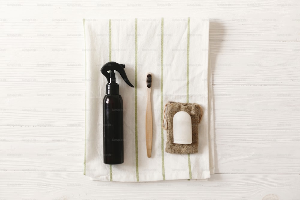 sustainable lifestyle, zero waste concept. eco bamboo toothbrush, handmade shampoo, crystal deodorant on towel, flat lay.  plastic free natural items for personal hygiene