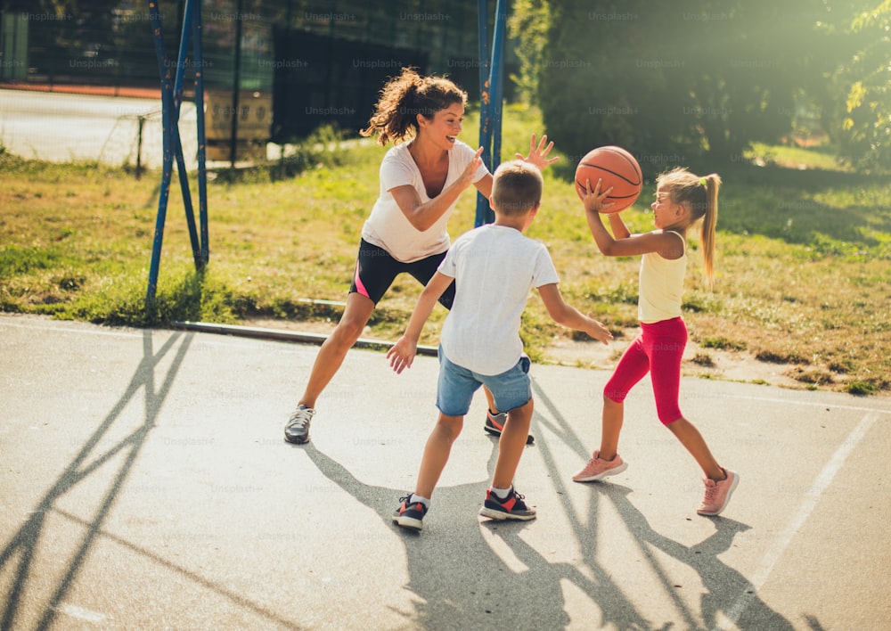 Family time. Family playing basketball together.  Moving activity.