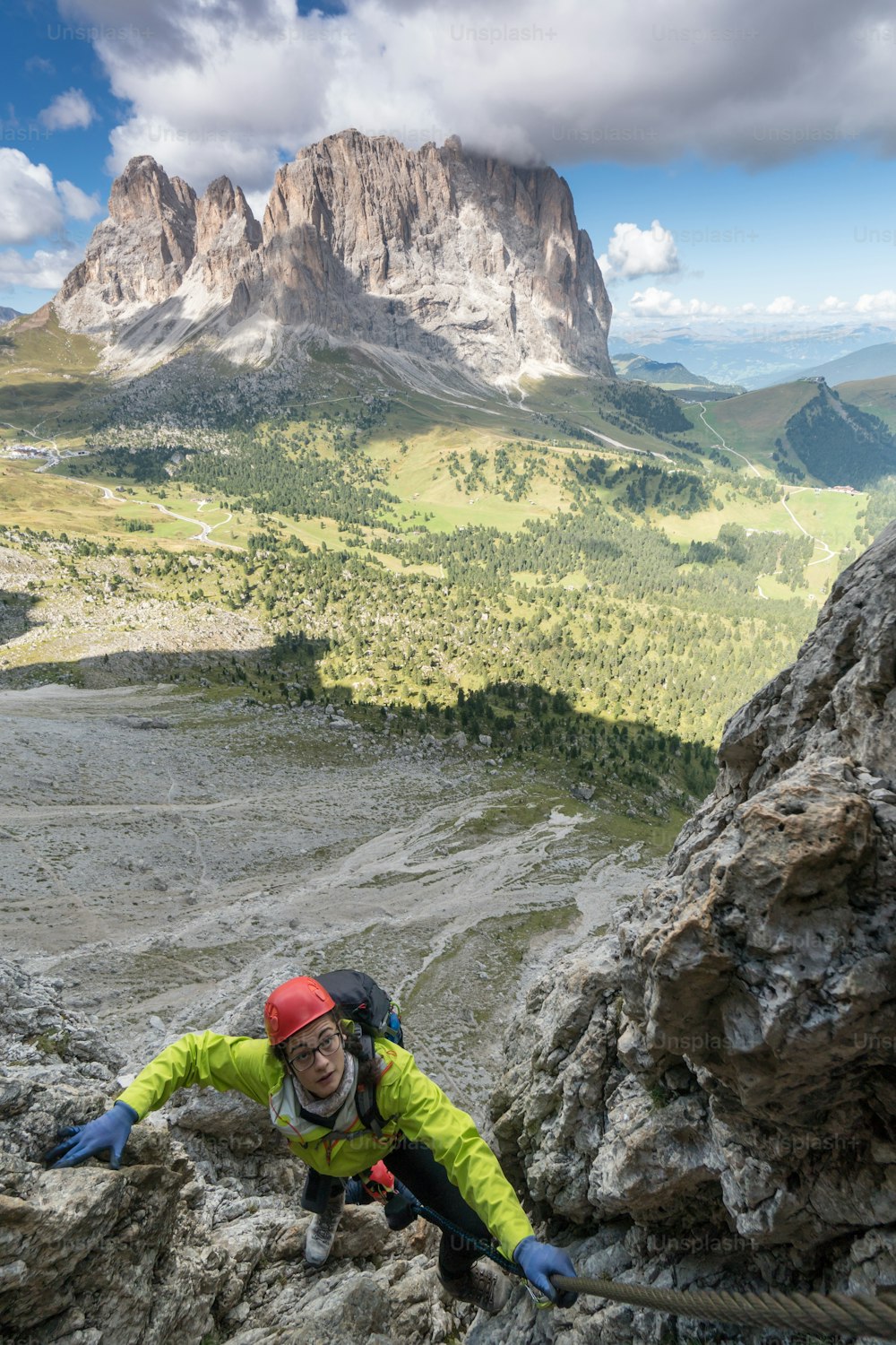 two young attractive female mountain climber in the Dolomites of italy with a great panorama view of the Langkofel and Passo Sella