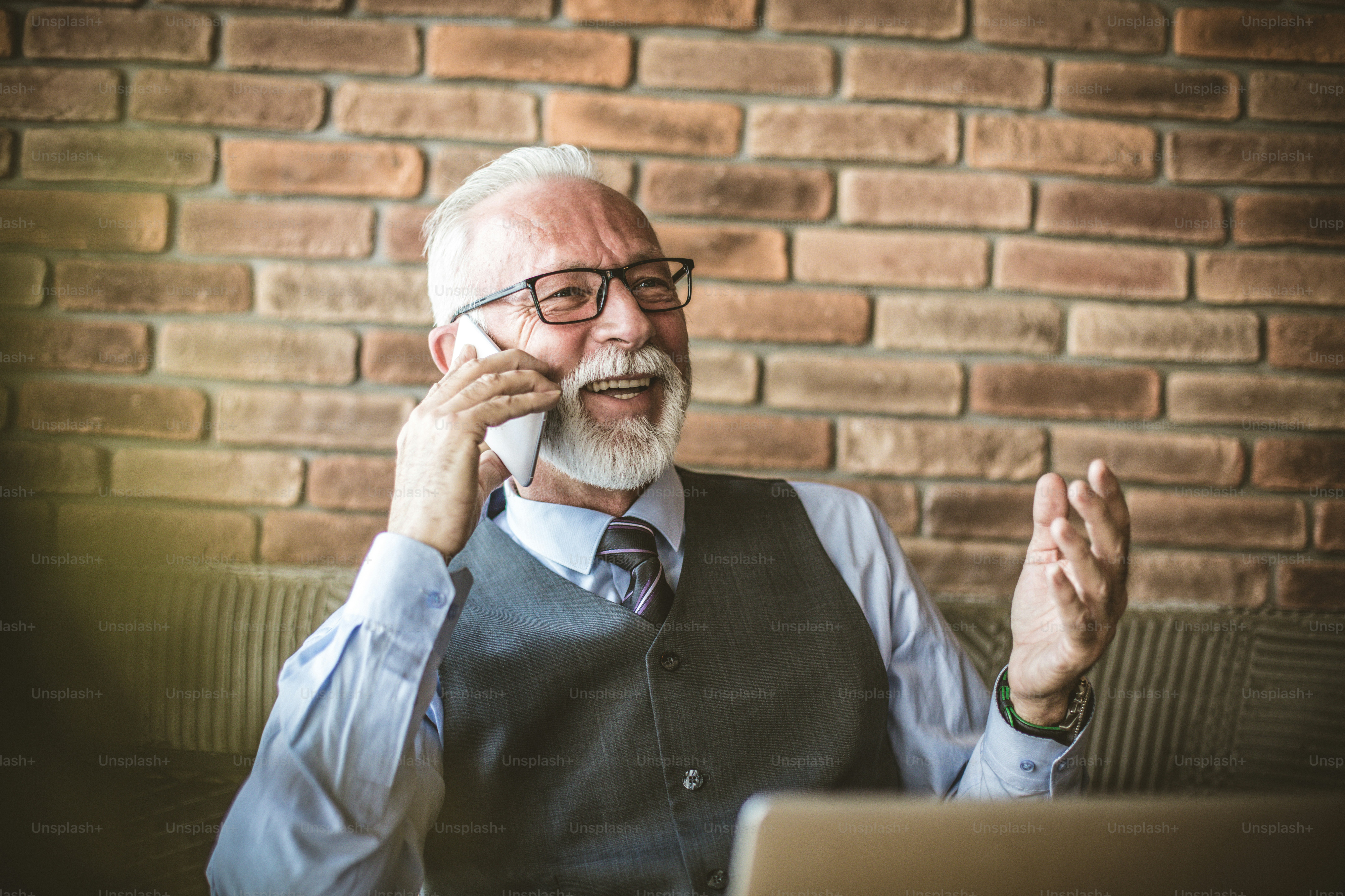 Portrait of senior businessman talking phone.