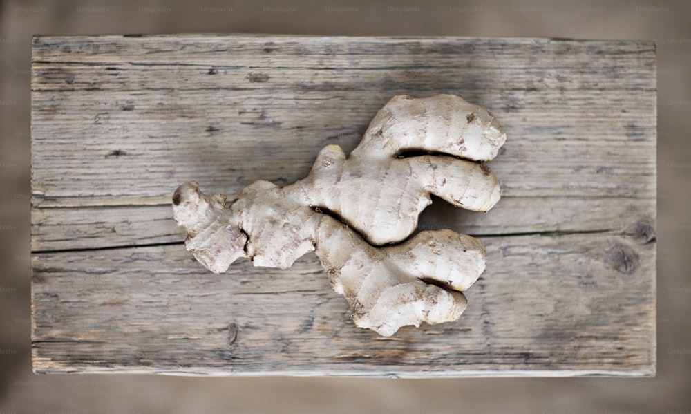 a close up of a bunch of ginger on a wooden surface
