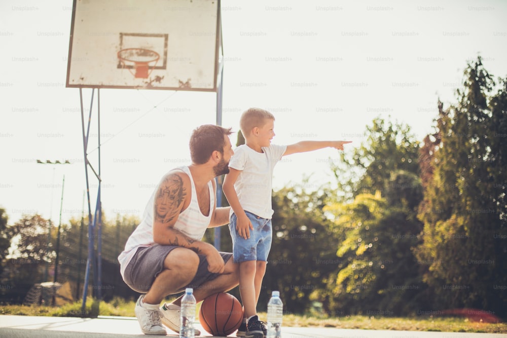 Let's go over there. Father and son on basket court.