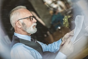 Senior man working with papers.