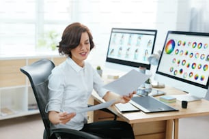 オフィスのコンピューターで作業する女性デザイナー。イラスト付きのWebデザインプロジェクトに取り組んでいる女性。高解像度