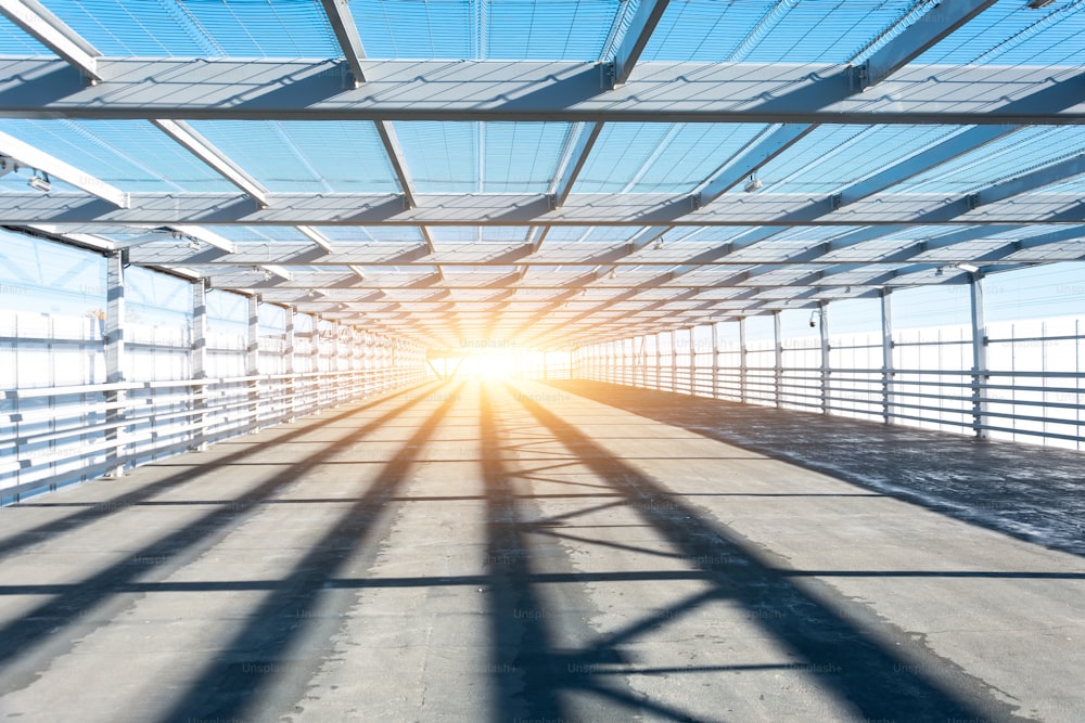 Metal tunnel grating with bright light at the end