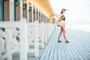 Beautiful woman near the old locker rooms on the beach in Deauville, famous french resort in Normandy