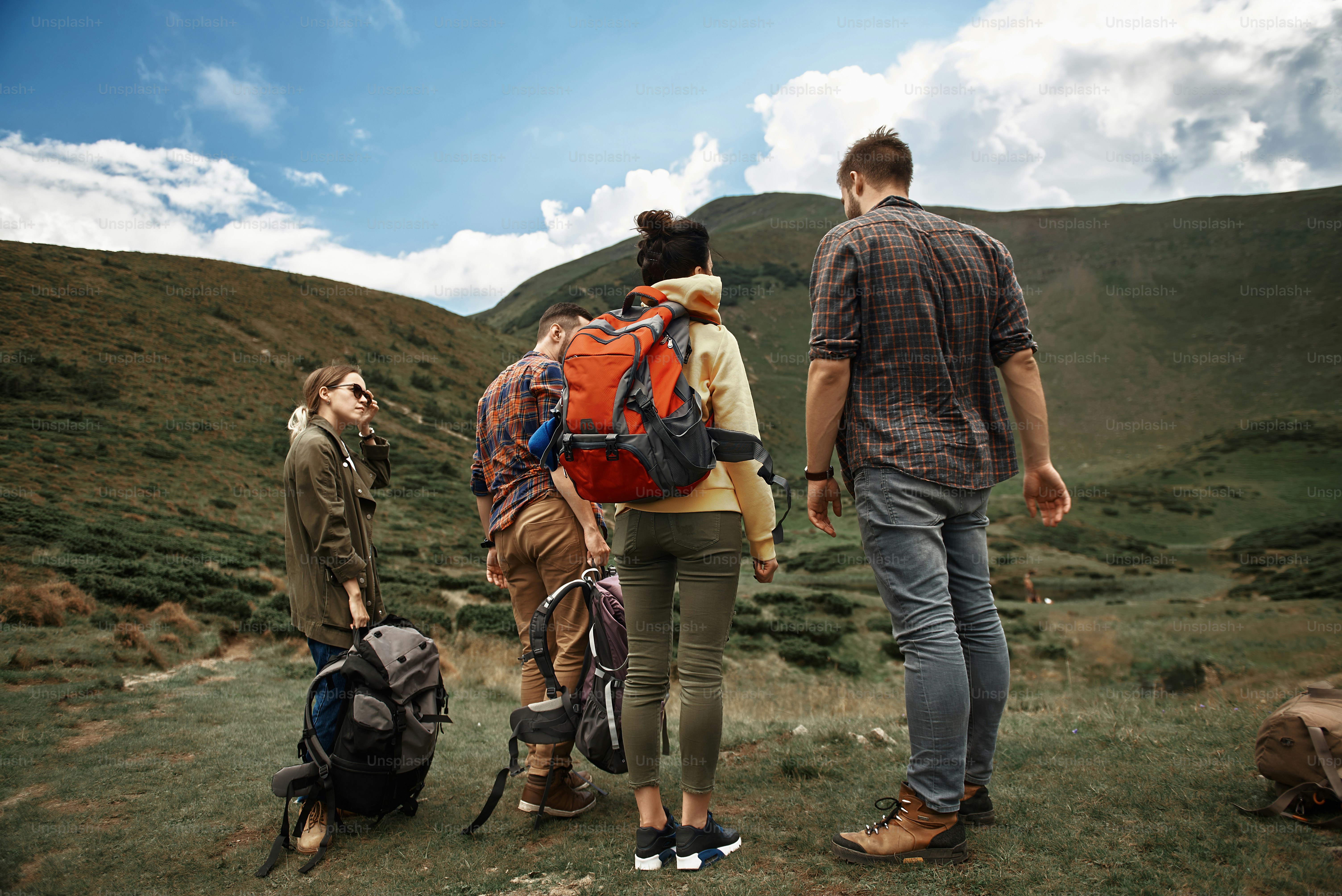 Tiresome journey. Four enthusiastic young hikers feeling tired and