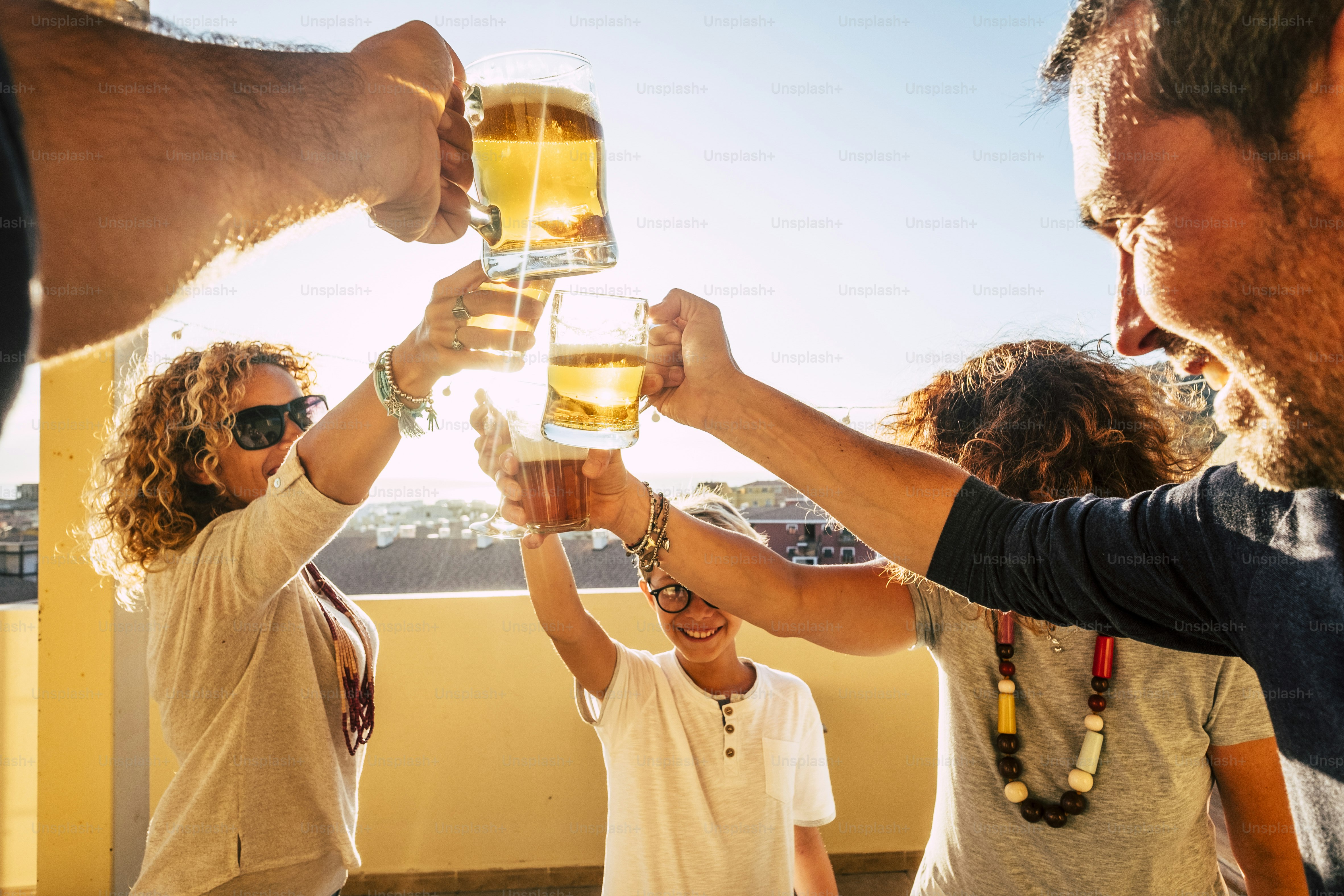 Group of people families and friends having fun together clinking with ...