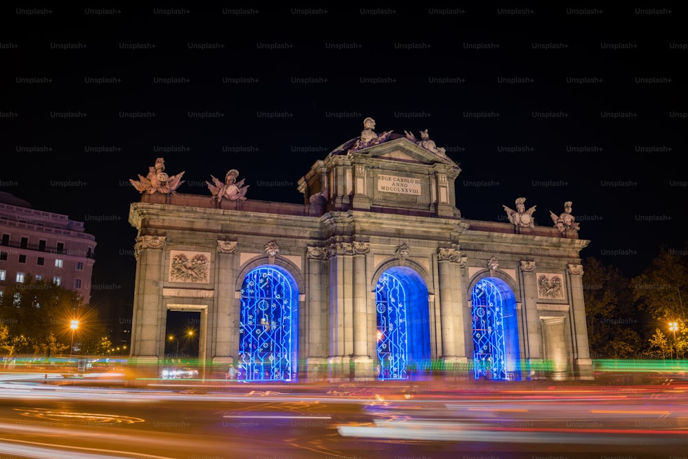 Night view of the Puerta de Alcalá in Madrid, decorated for Christmas.