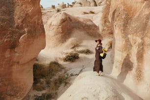 Woman Traveling, Exploring Nature Of Rocks Valley. Female Traveler Travel At Desert Canyon. High Resolution
