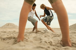 a couple of people kicking around a soccer ball