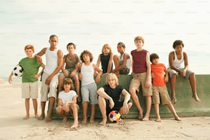 a group of children posing for a picture on the beach