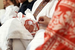 baptism baby. cute little feet of a girl at christening ceremony with priest in church