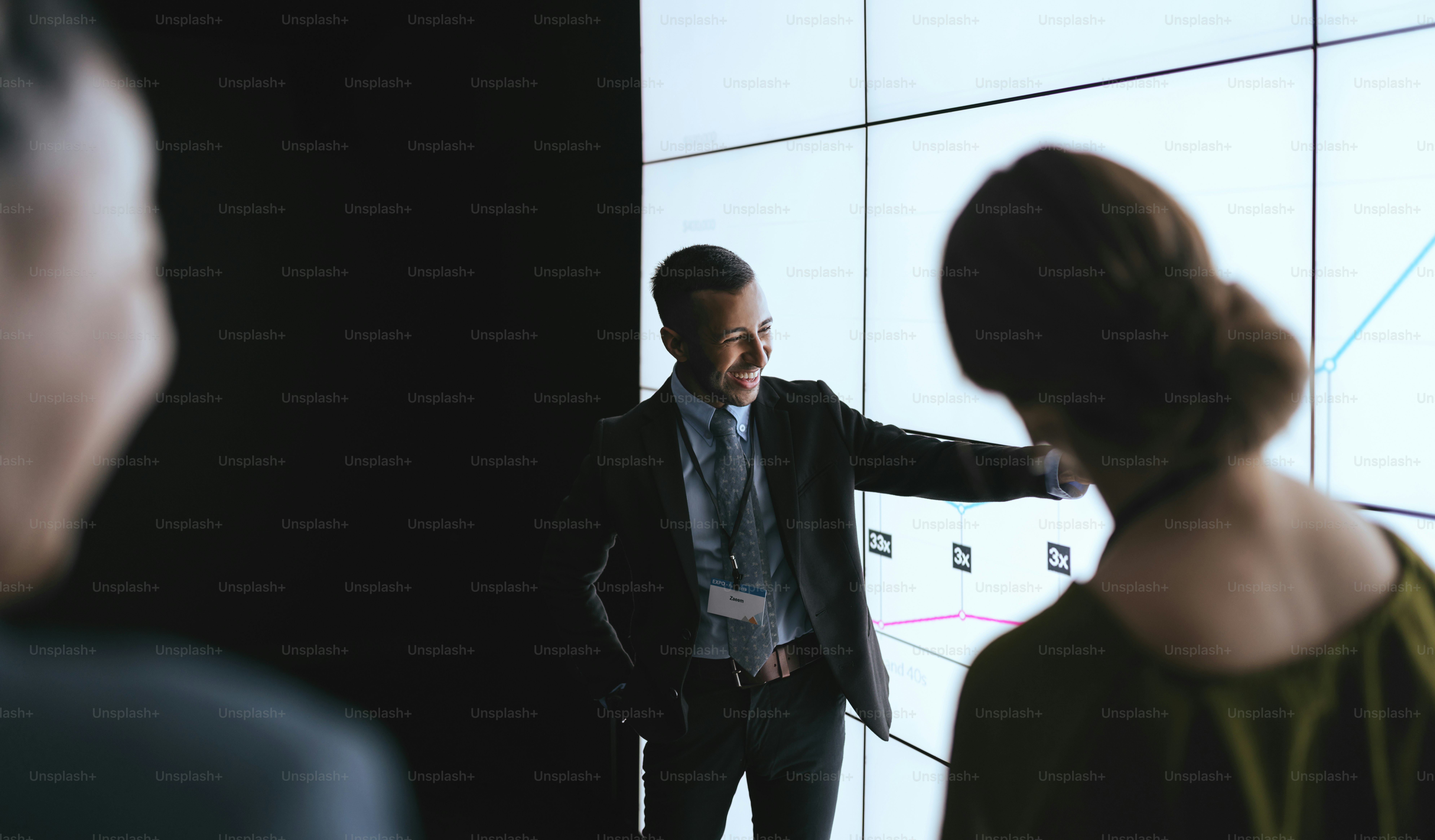 Indian businessman pointing at digital screen during a presentation