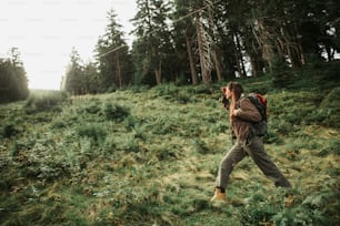 I lost my way. Full length portrait of brave girl with backpack searching the road while walking through coniferous wood