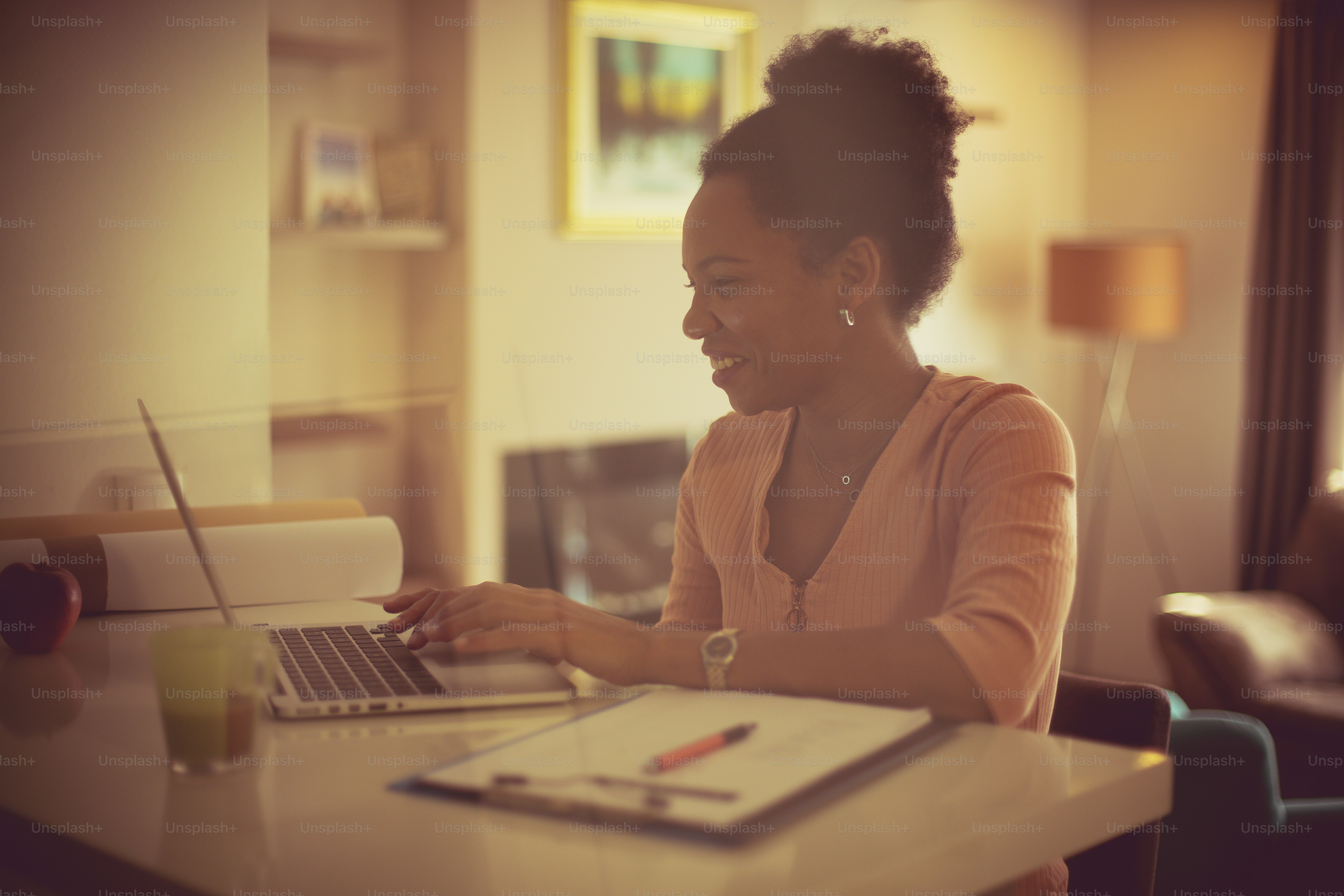 Cheerful mail. African American woman working at home.