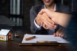 Estate agent shaking hands with his customer after contract signature