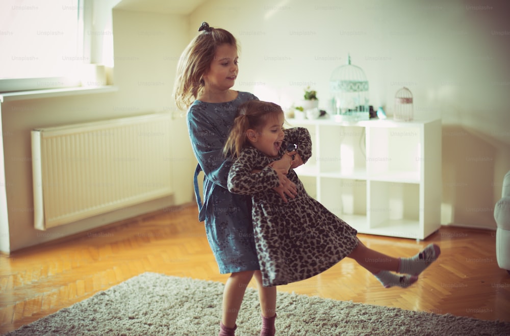 Sister is here to get you through the fun. Two little girls playing at home.
