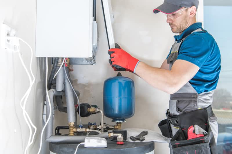 A technician inspecting a furnace
