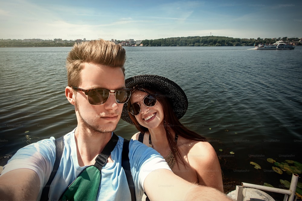 happy stylish couple taking selfie, having fun on the beach, summer vacation