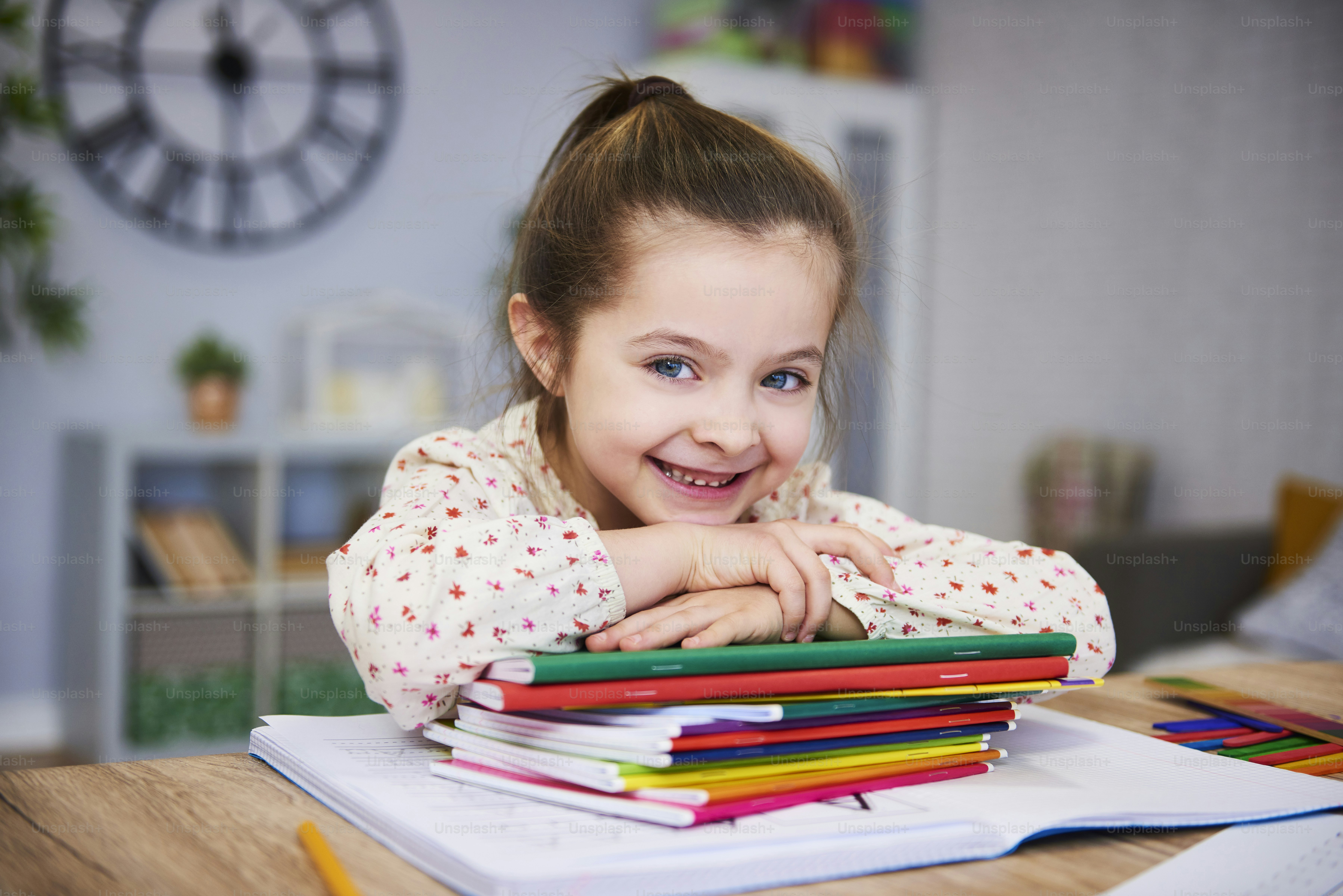 Smiling girl studying at home